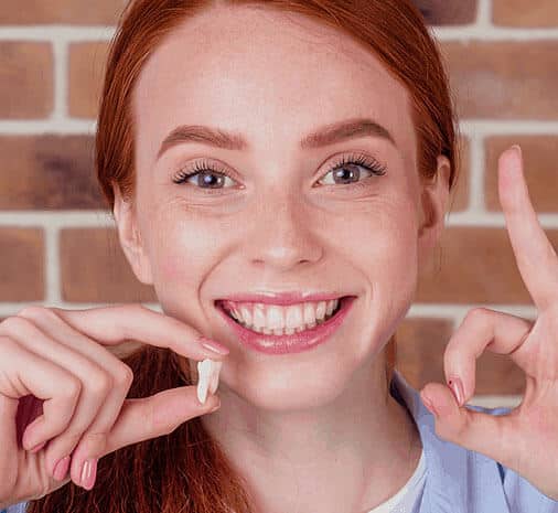 Image Of Wisdom Teeth Extraction In Austin - Girl Is Holding Wisdom Teeth